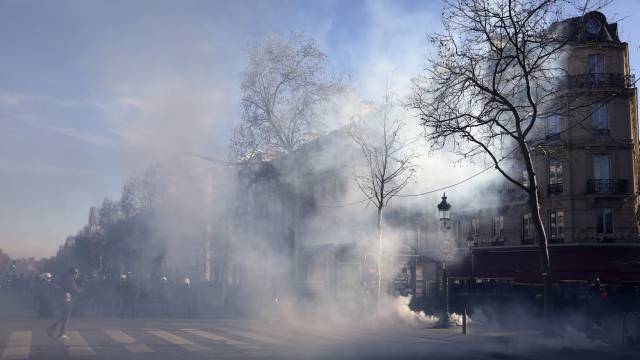 Tear gas grenades a fired during a protest in Paris.