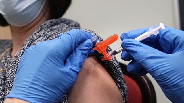 A woman receiving a COVID-19 vaccine injection.
