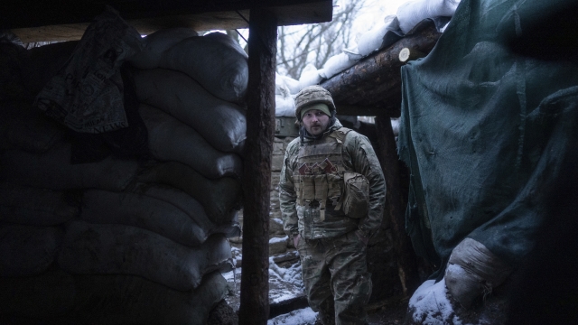 A Ukrainian serviceman stands at a shelter at the frontline positions near Zolote, Ukraine