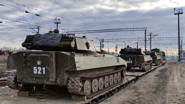 Russian armored vehicles are loaded onto railway platforms after the end of military drills in South Russia.