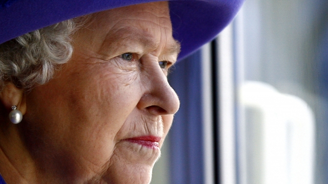 England's Queen Elizabeth II looks out a window