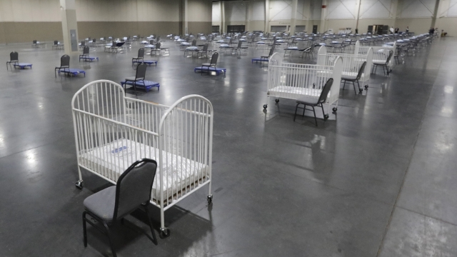 Cots and cribs are arranged in alternate care site for hospital overflow amid the COVID-19 pandemic.