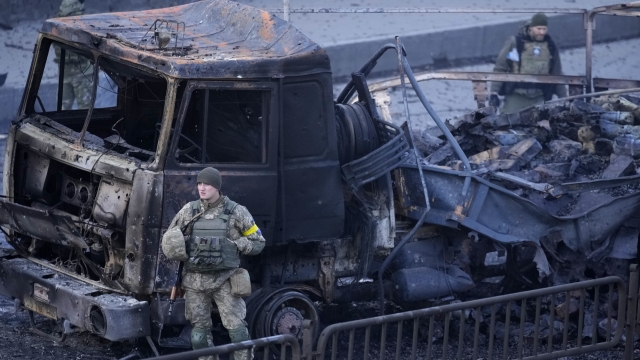 Ukrainian troops inspect the site following a Russian airstrike in Kyiv, Ukraine