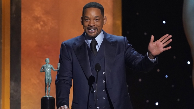 Will Smith accepts the award for outstanding performance by a male actor in a leading role for "King Richard"