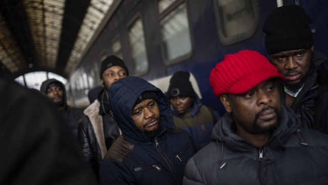 African residents in Ukraine wait at the platform inside Lviv railway station