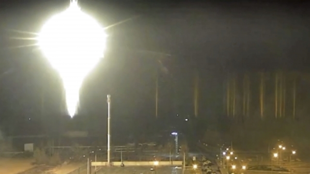 This image made from a video released by Zaporizhzhia nuclear power plant shows bright flaring object landing
