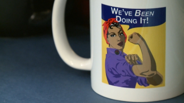 A mug with a picture of a woman and a quote saying "We've been doing it!"