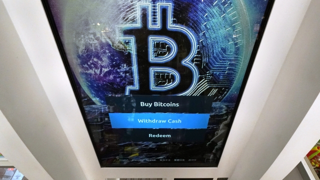 The Bitcoin logo appears on the display screen of a cryptocurrency ATM
