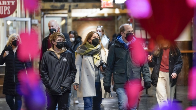 Shoppers wear masks while walking through an indoor market in New York