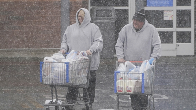Snow falls on shoppers pushing shopping carts