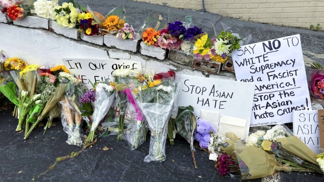 Flowers, candles and signs are displayed at a makeshift memorial in Atlanta in 2021.