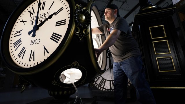 A man sets a clock