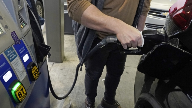 A customer pumps gasoline into his car.