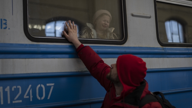 Displaced Ukrainians on a Poland-bound train bid farewell in Lviv, Ukraine