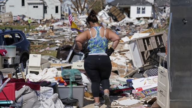 Woman stares at wreckage from a tornado