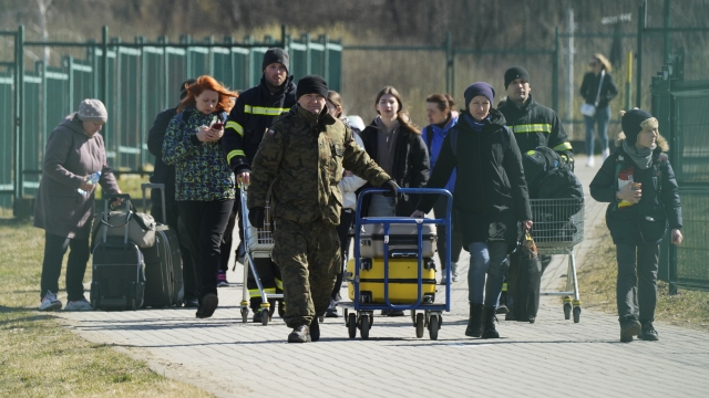 Refugees walk at the Poland-Ukraine border