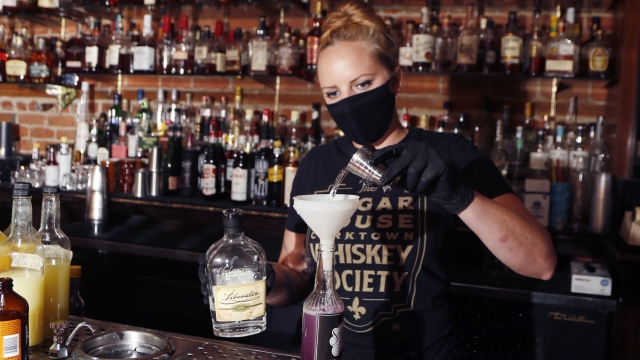 Bartender pours a drink