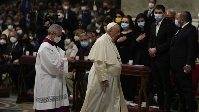 Pope Francis walks past Melitopol Mayor Ivan Fedorov, second from right, and Ukrainian lawmakers during a Easter vigil.