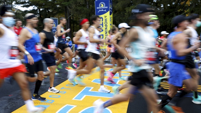 Runners cross the starting line of the 125th Boston Marathon in 2021.
