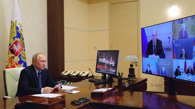 Russian President Vladimir Putin chairs a meeting.