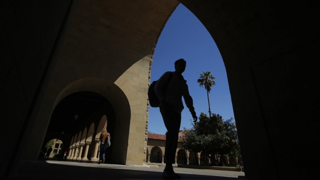 Pedestrians walk on the campus at Stanford University.