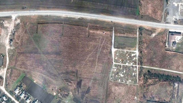Satellite image shows an overview of the cemetery in Manhush, some 20 kilometers west of Mariupol.