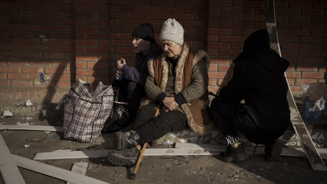 People fleeing the village of Ruska Lozova wait at a screening point in Kharkiv, Ukraine