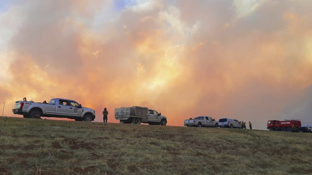 Plumes of smoke from wildfires are seen on a New Mexico highway.