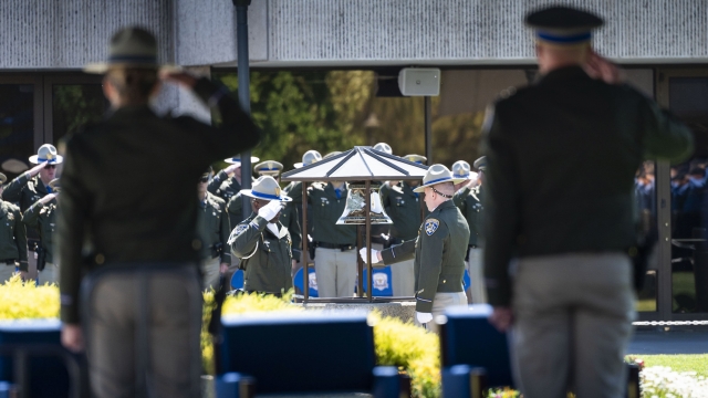 Officers stand at a memorial service.