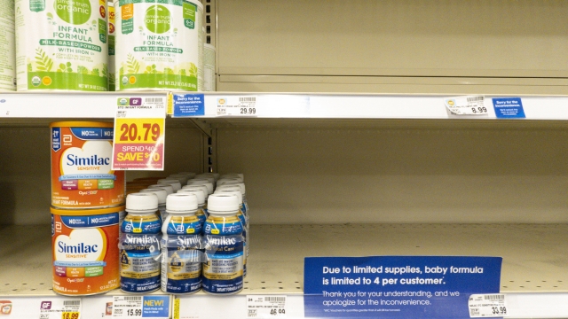 Baby formula is displayed on a store shelf.