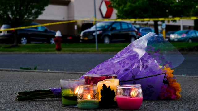 Flowers and candles lay outside the scene of a shooting at a supermarket, in Buffalo, N.Y.