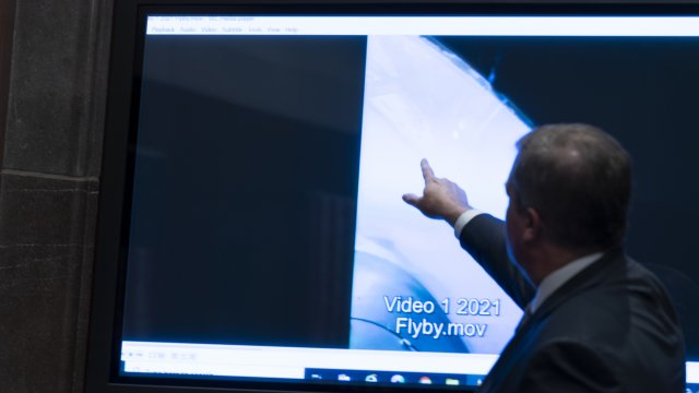 Deputy Director of Naval Intelligence Scott Bray points to a video display of a UAP.