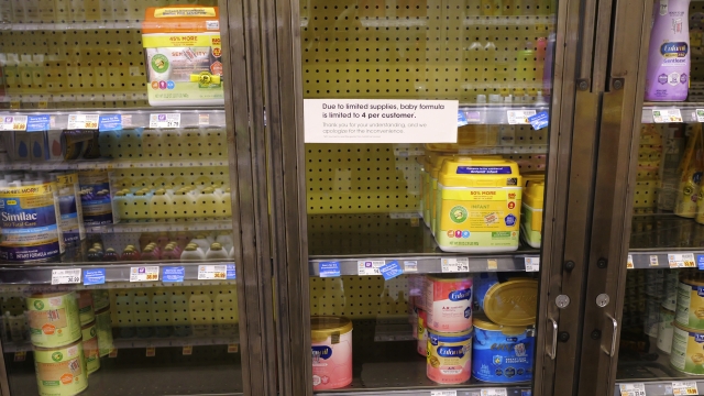 Baby formula is displayed on the shelves of a grocery store.