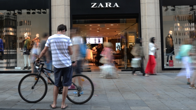 People walk past a downtown Zara store.