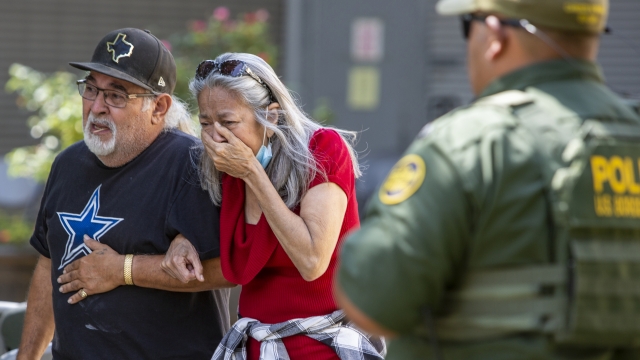 A woman cries as she leaves the Uvalde Civic Center after a school shooting