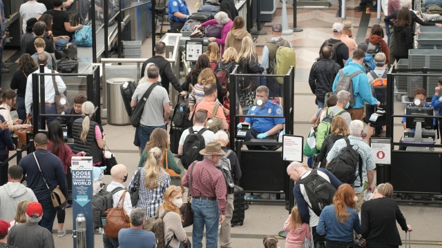 Travelers move through a security checkpoint