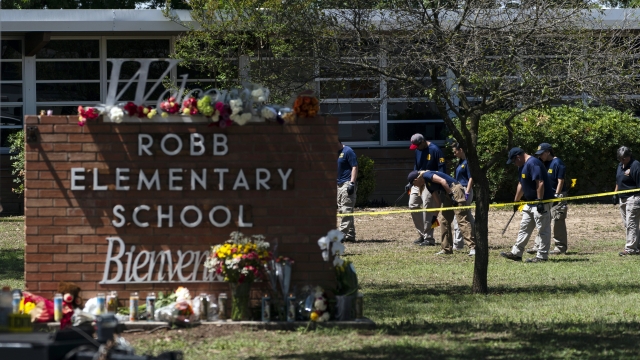 Investigators search for evidence outside Robb Elementary School in Uvalde, Texas