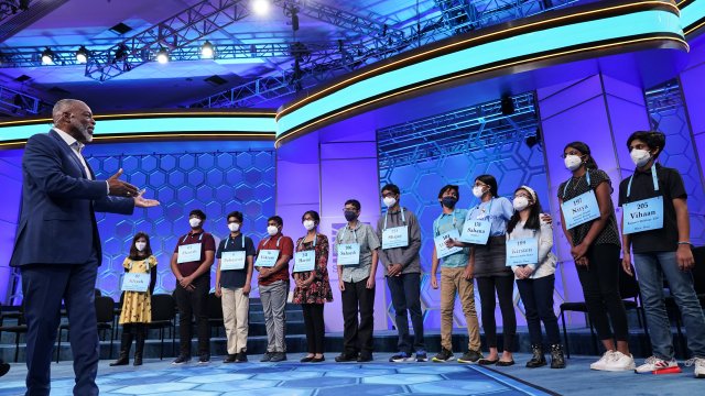 LeVar Burton gestures to 12 Spelling Bee finalists.