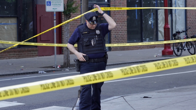 Philadelphia Police investigators work the scene of a fatal overnight shooting on South Street in Philadelphia