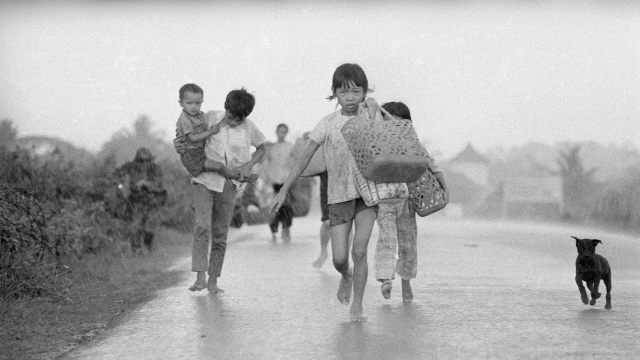Unidentified Trang Bang villagers flee down Route 1 after a misdirected napalm attack by South Vietnamese pilots