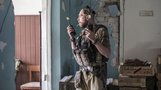 A Ukrainian soldier holds radios during heavy fighting on the front line in Severodonetsk.