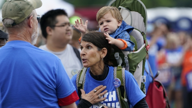 A woman carries her grandson as she attends the second March for Our Lives rally in support of gun control