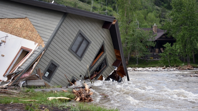 A house was pulled into Rock Creek in Red Lodge, Mont., by raging floodwaters.