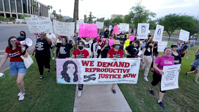 Abortion rights protesters march around the Arizona Capitol