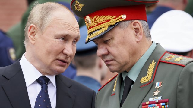 Russian President Vladimir Putin speaks with Russian Defence Minister Sergei Shoigu