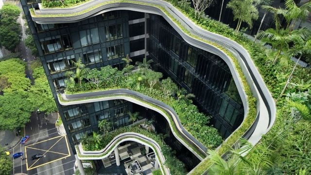 A building with green roofs and balconies is shown.
