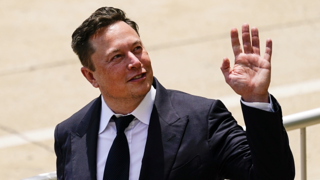 Elon Musk waving.