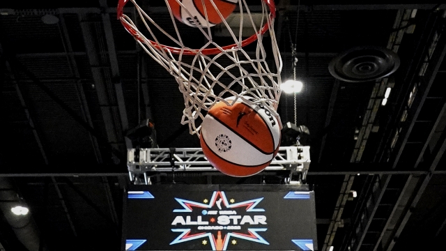 A ball goes through the basket during practice for the WNBA All-Star basketball game.