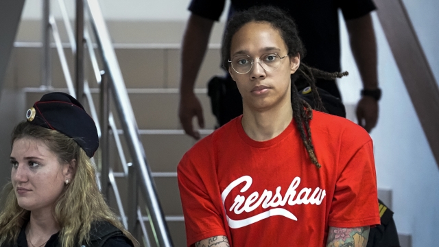 Brittney Griner is escorted to a courtroom.