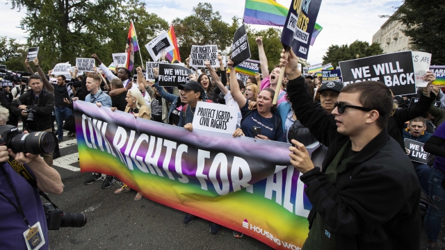 Supporters of LGBTQ rights stage a protest on the street in front of the U.S. Supreme Court in Washington